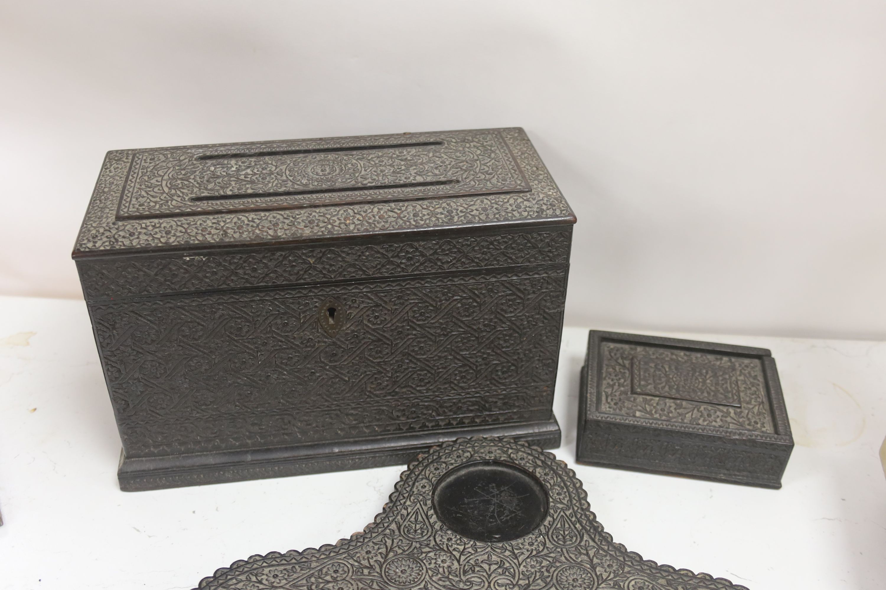 A James Cockings leather box containing a vellum patent letter with Queen Victoria Grand seal with an Indian carved box, pen stand etc